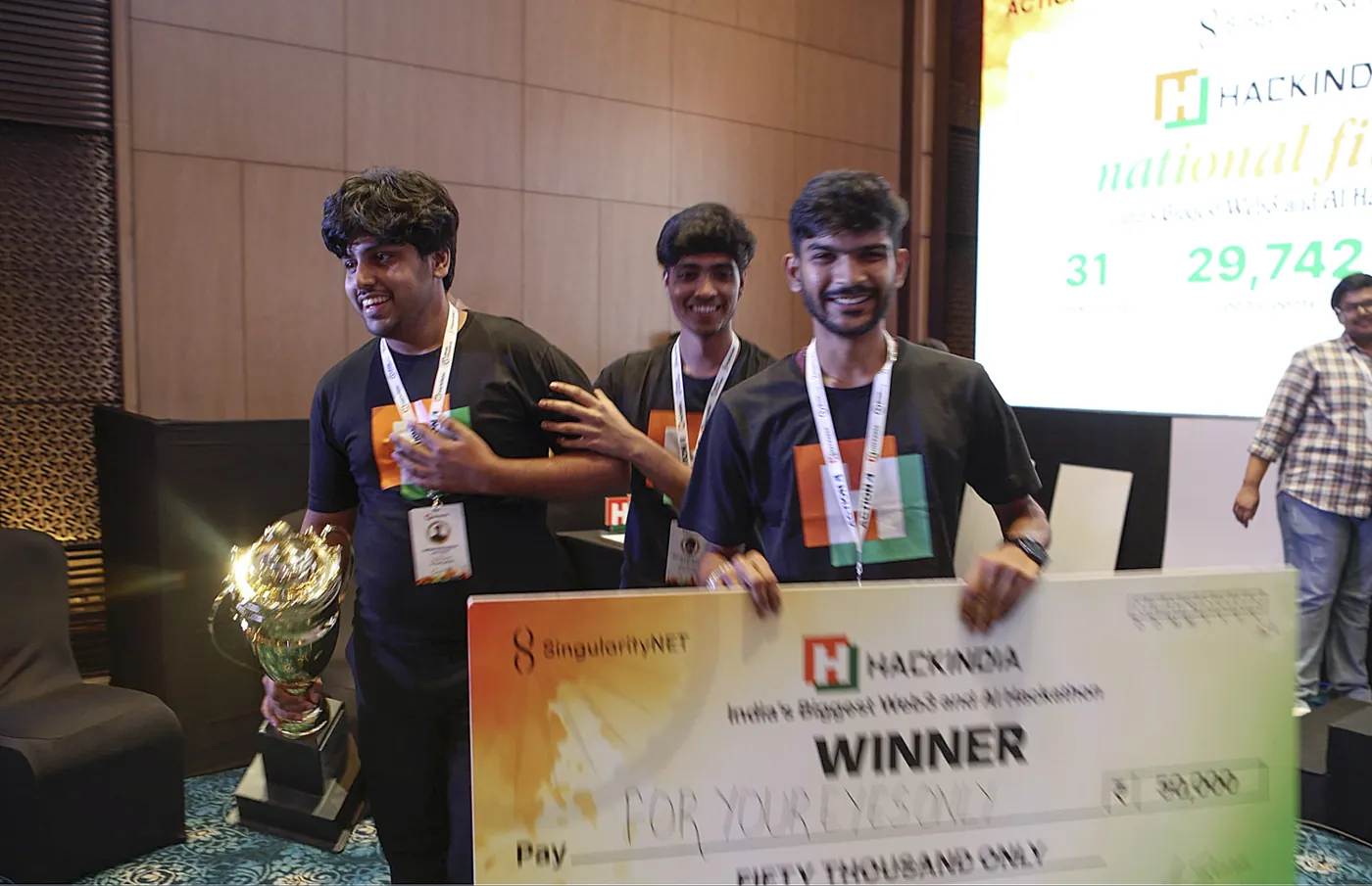 Team For Your Eyes Only walking up with the HackIndia winner cheque